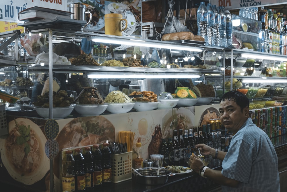 man sitting in front of display counter