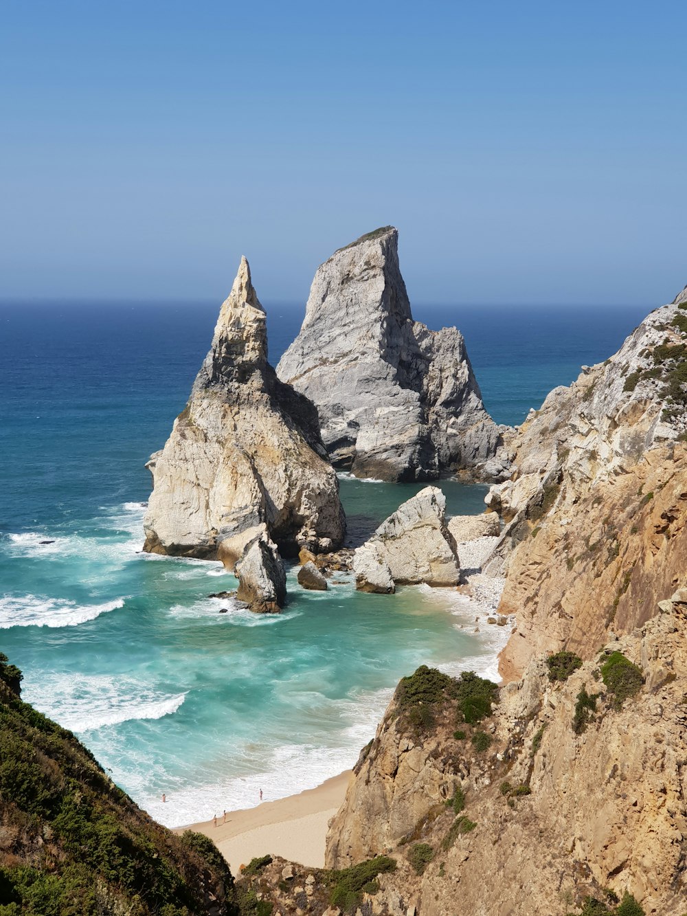 landscape photo of stone formation in ocean