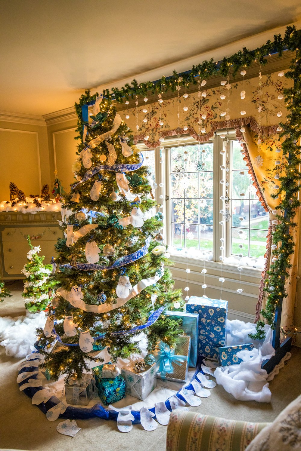 green Christmas tree near glass window