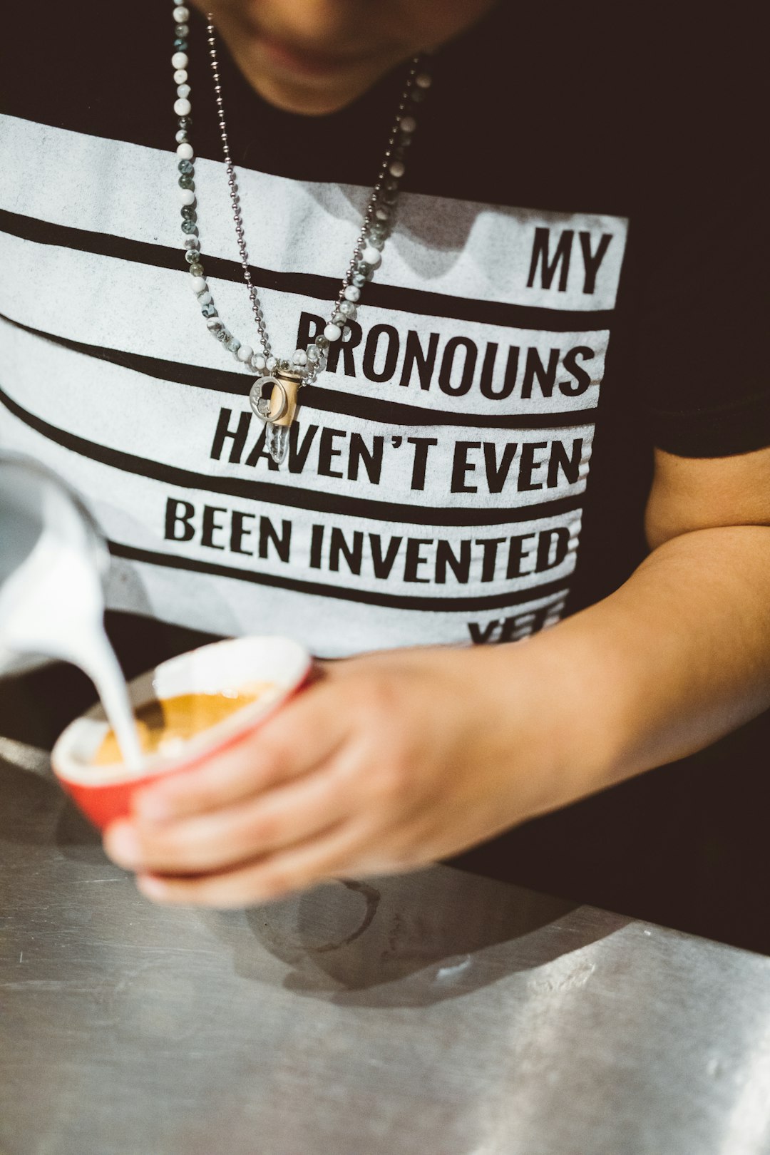 man holding cup of coffee and milk