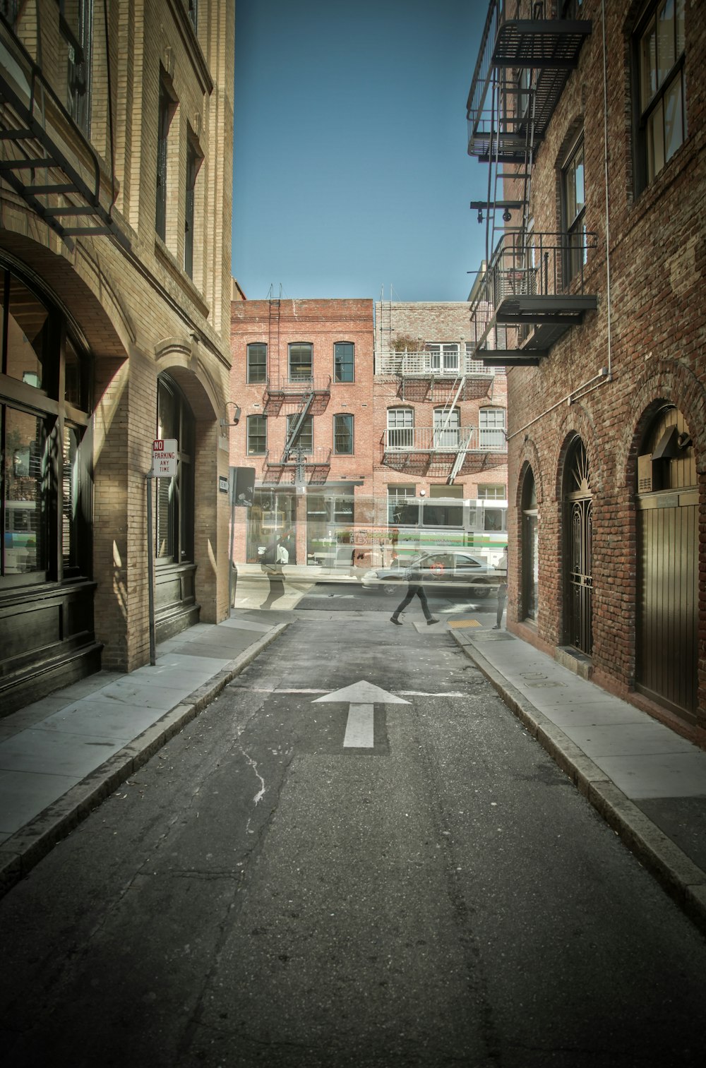 gray concrete road and brown buildings during daytime