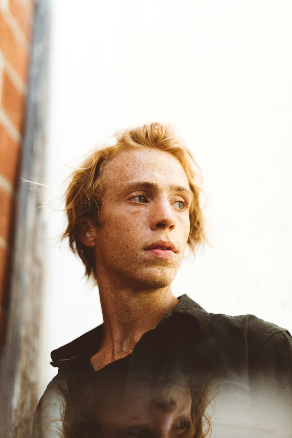 man wearing black collared shirt outdoor