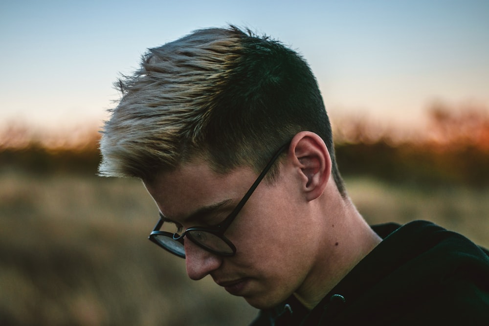 man in black collared shirt and black framed eyeglasses