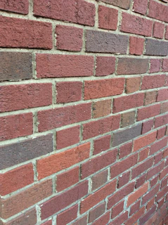 Close-up of a freshly repointed brick wall highlighting clean, precise mortar lines.