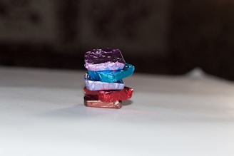 Beautifully wrapped chocolate gift boxes stacked neatly on a store shelf.