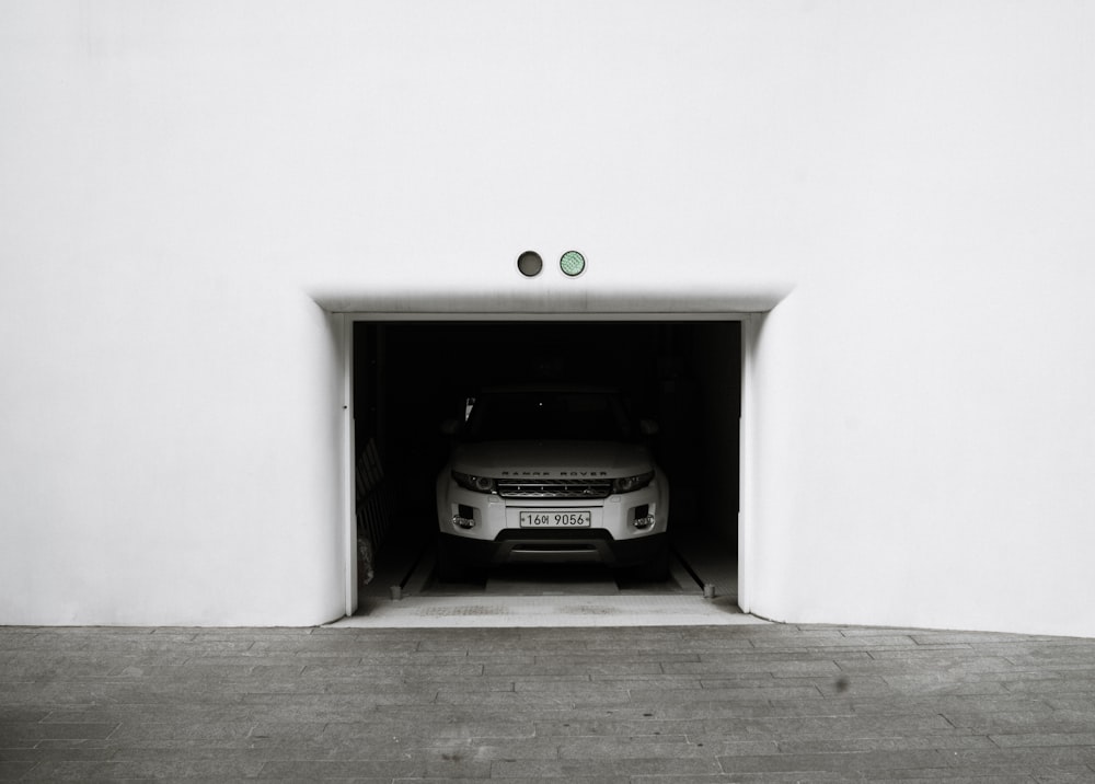 silver Land Rover Range Rover SUV parked inside garage