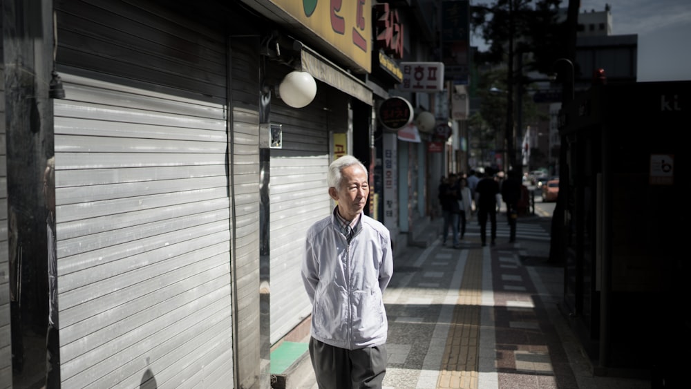 man walking near roller shutter