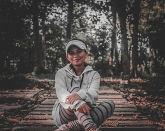 A stylish woman wearing a cozy hoodie in a casual outdoor setting.