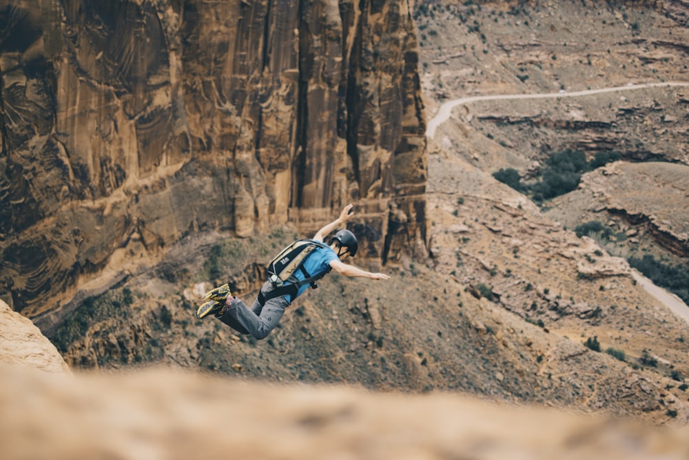 man jumping on cliff