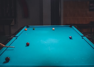 shallow focus photo of blue billiard table