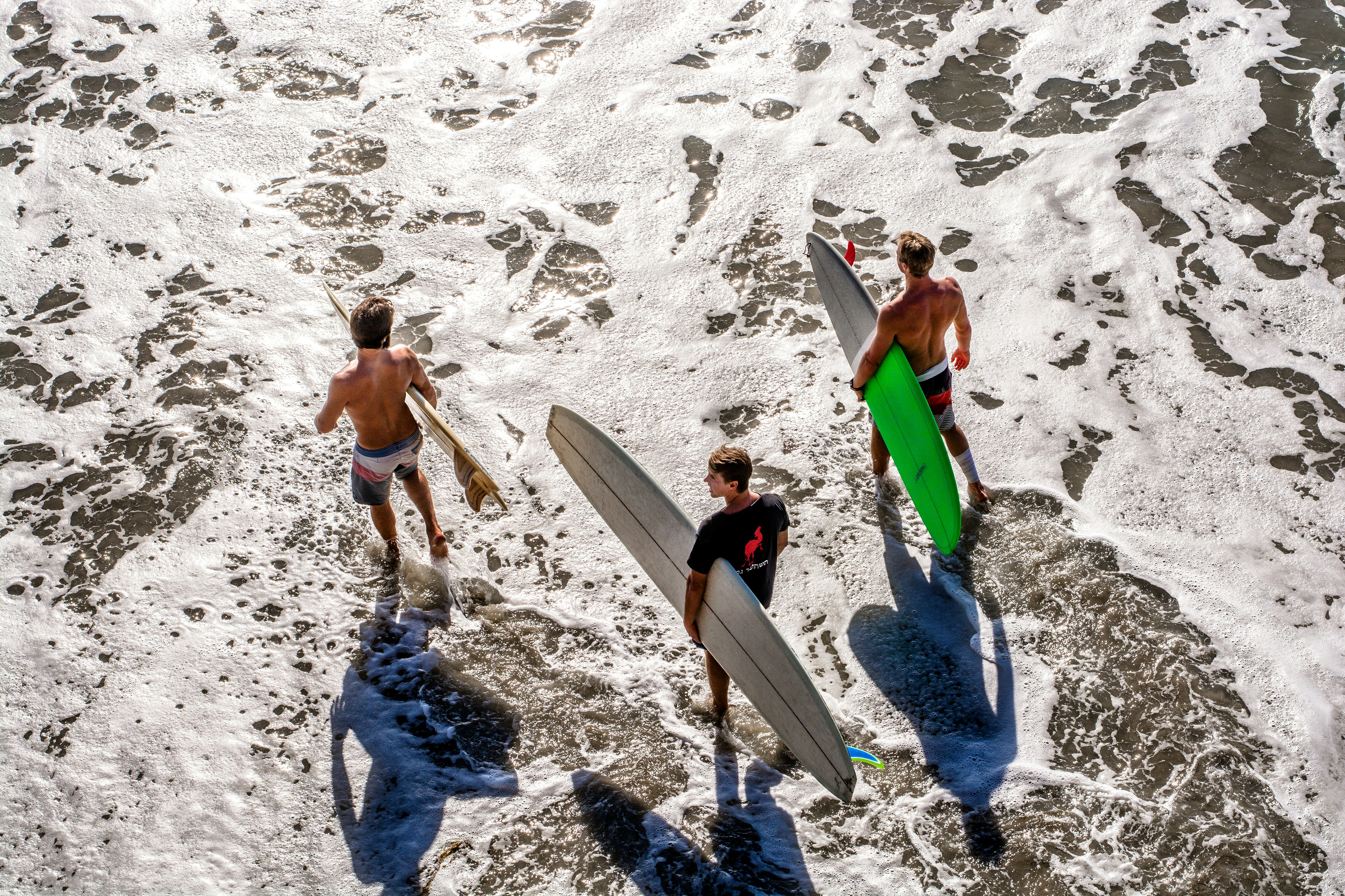 three men about to surf