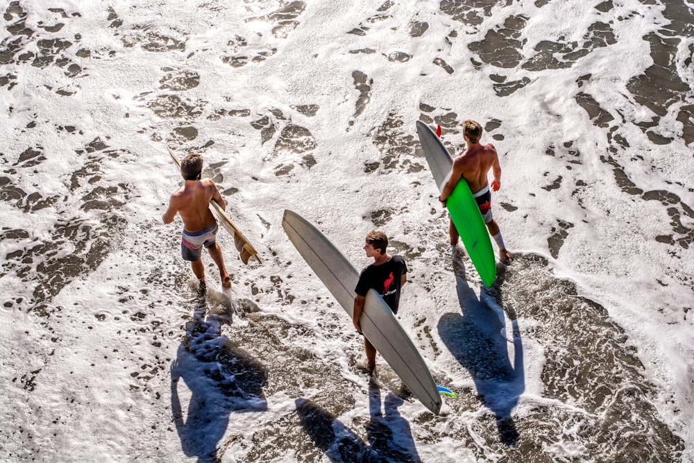three men about to surf