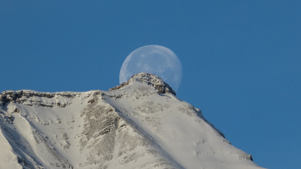 white mountain across gray moon