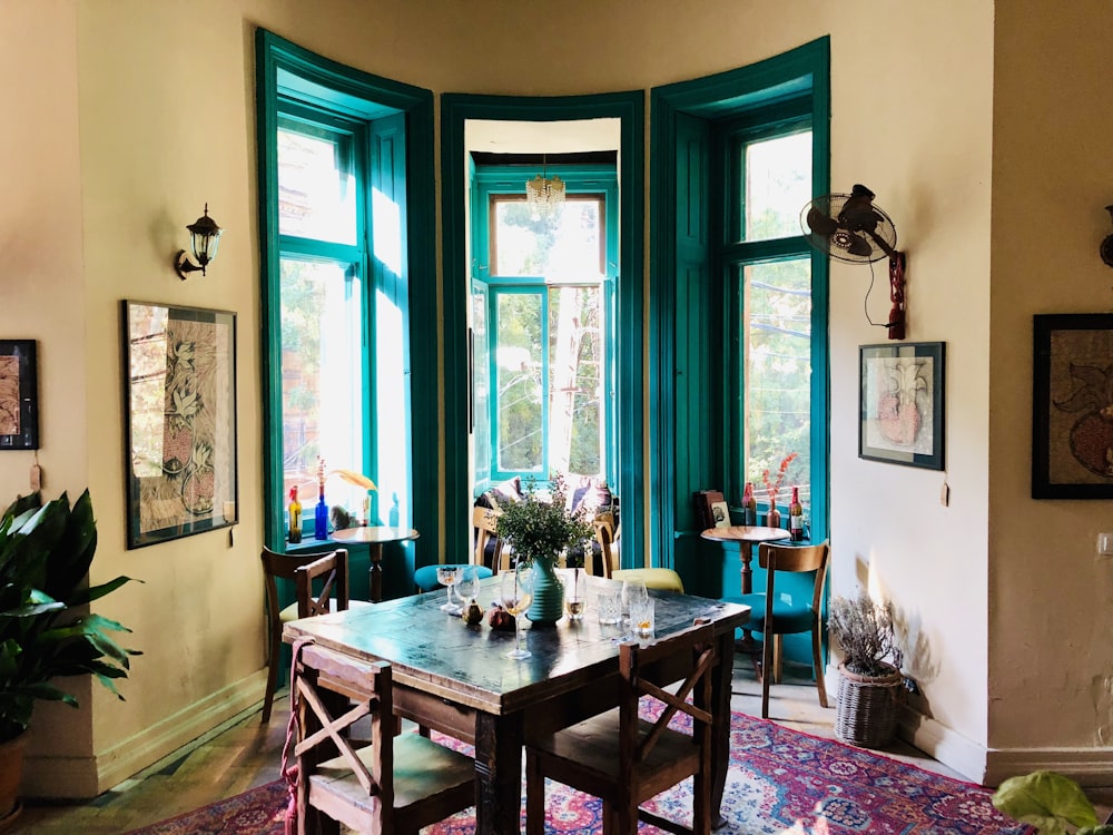 brown wooden table near painting mounted on wall