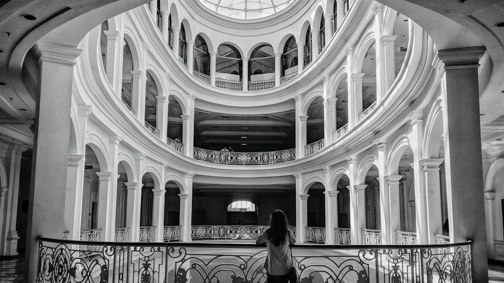 woman standing beside balustrade