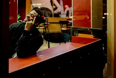 man leaning on the table candid google meet background