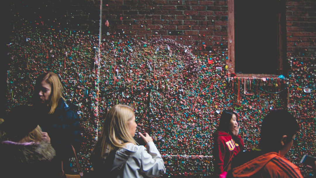 people beside red brick building