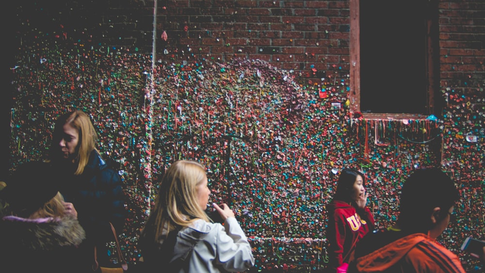 people beside red brick building