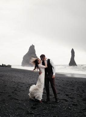  groom and bride kissing on beach in iceland