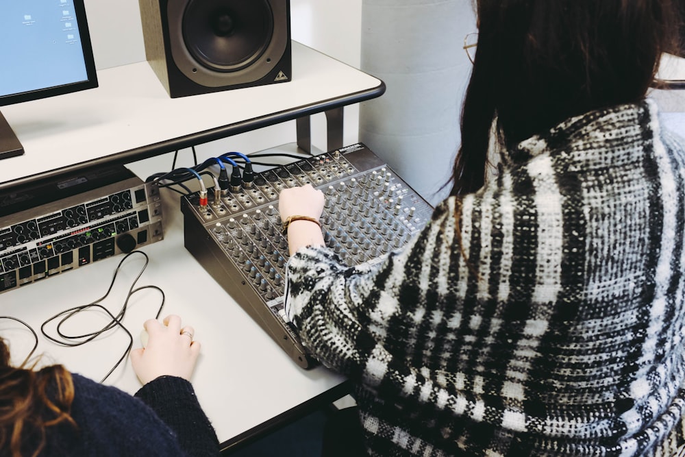 woman arranging the mixing console