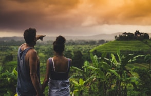 man and woman looking at hill