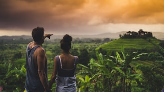 man and woman looking at hill