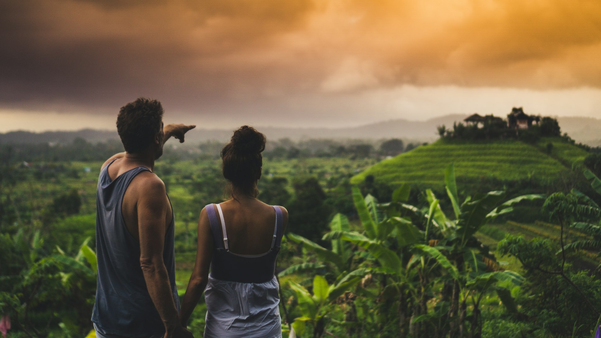 a couple looking over some greenery in Bali