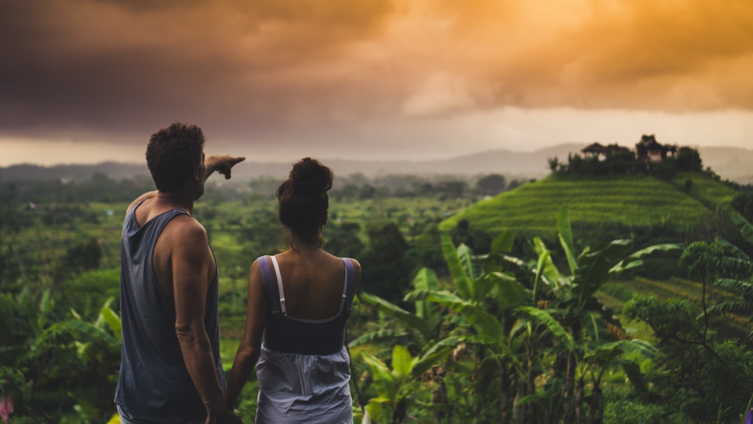 man and woman looking at hill,