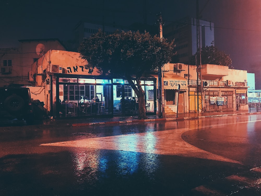 stored open near tree and street at night