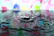 Close-up of a vibrant, colorful ink splash on a smooth white surface.