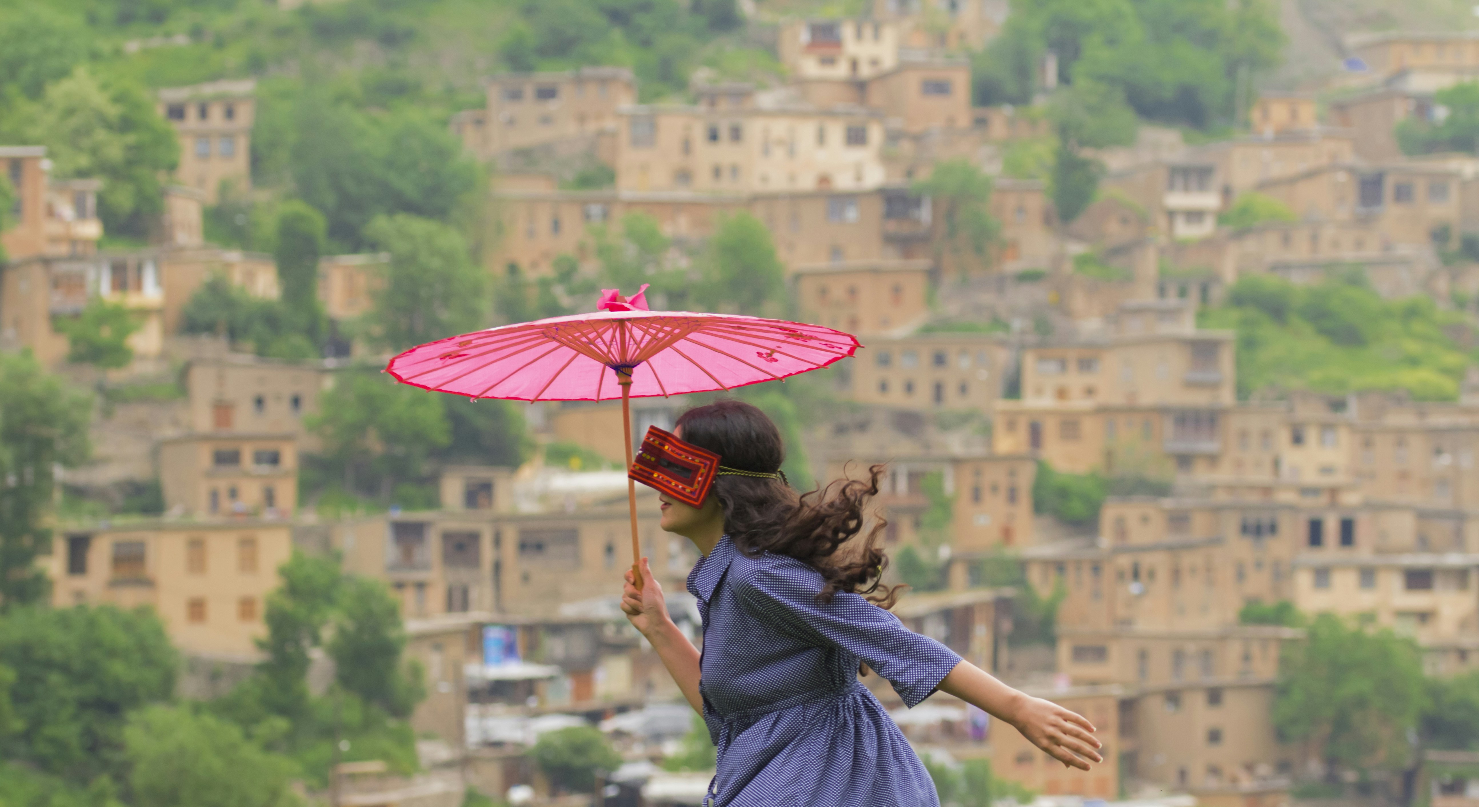 woman holding pink Japansenes paper umbrella