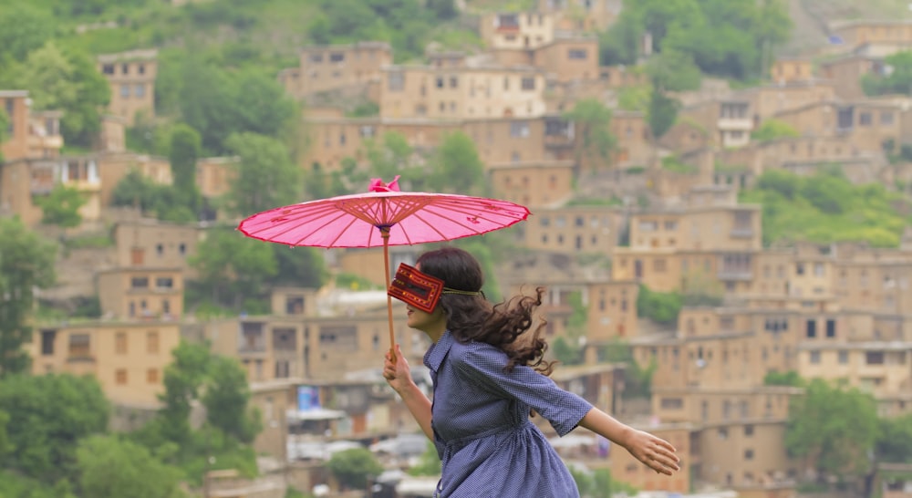 woman holding pink Japansenes paper umbrella