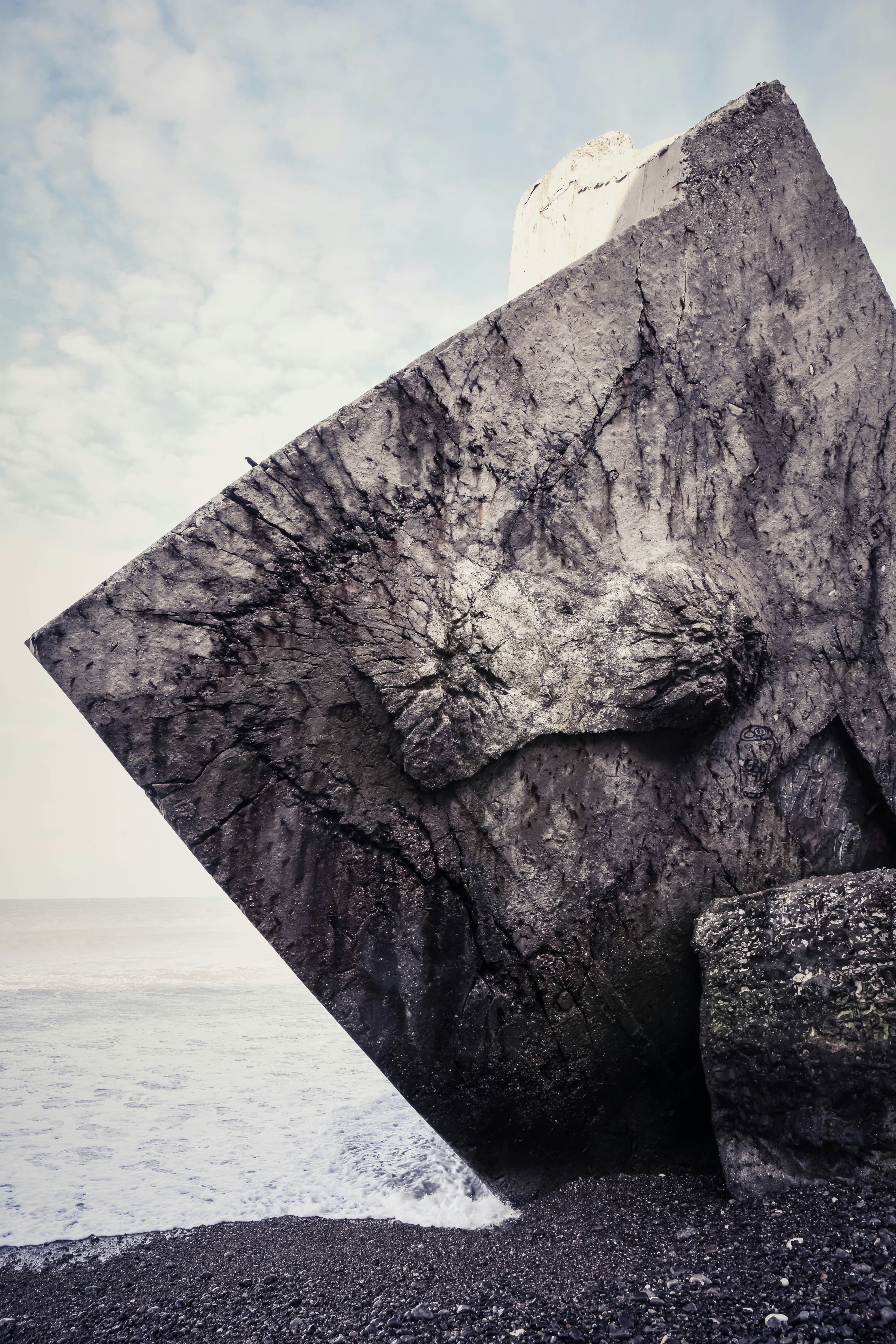 gray rock across body of water