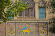 Intricate mosaic tiles decorating an ancient building facade.