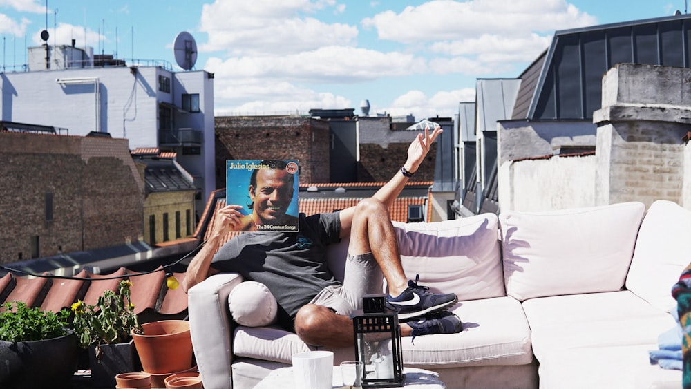 man sitting on sofa