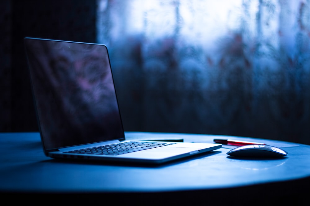 selective focus photography of laptop on table