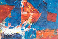 An abstract painting featuring bold strokes of blue and orange hues.