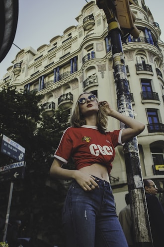 A model wearing a vibrant graphic t-shirt against a city backdrop.