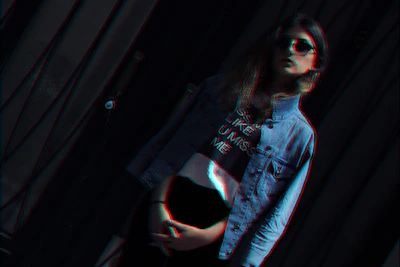 Editorial shot featuring a futuristic oversized t-shirt with glassmorphism effects and glowing edges.