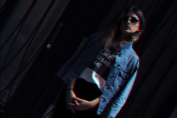 Close-up of a streetwear tee featuring glitch overlays and bold typography on a neon-lit background