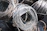 Close-up of stainless steel coils stacked neatly in a bright industrial warehouse.
