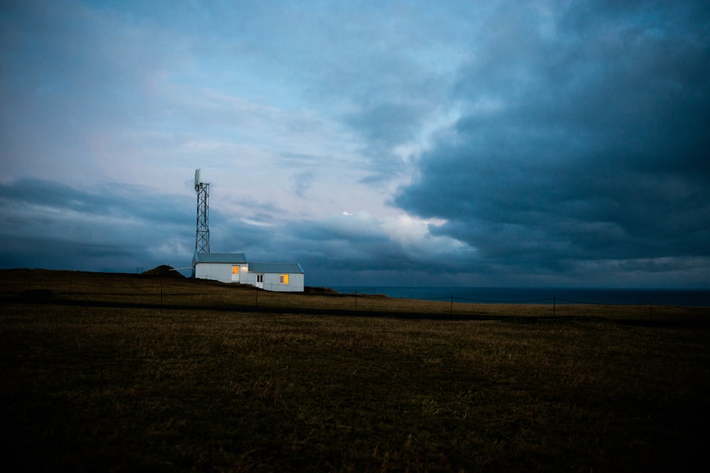 grey clouds above tower and barn