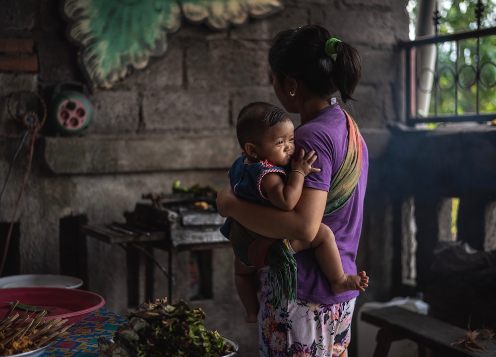 woman carrying baby