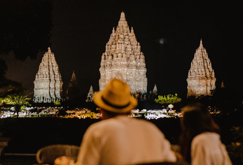 couple sitting on chair in front of buildings