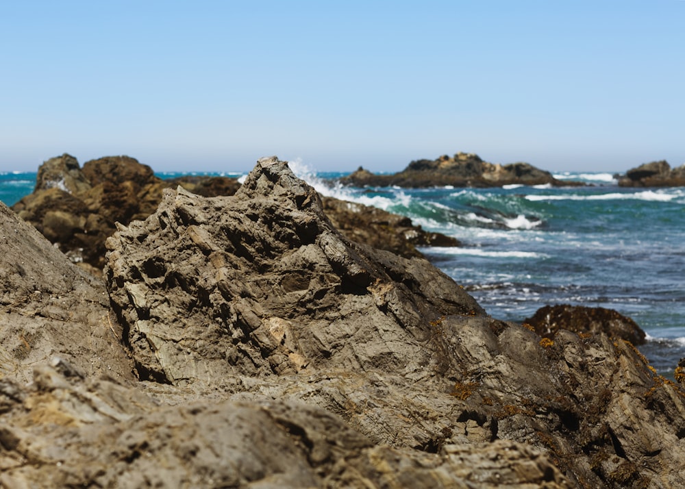 ocean waves crashing on rock formation