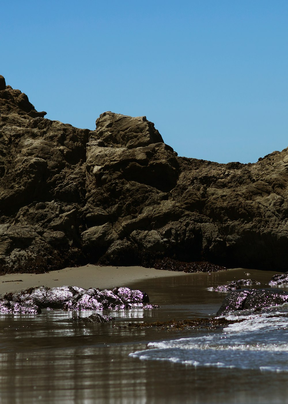 seashore near rock during daytime