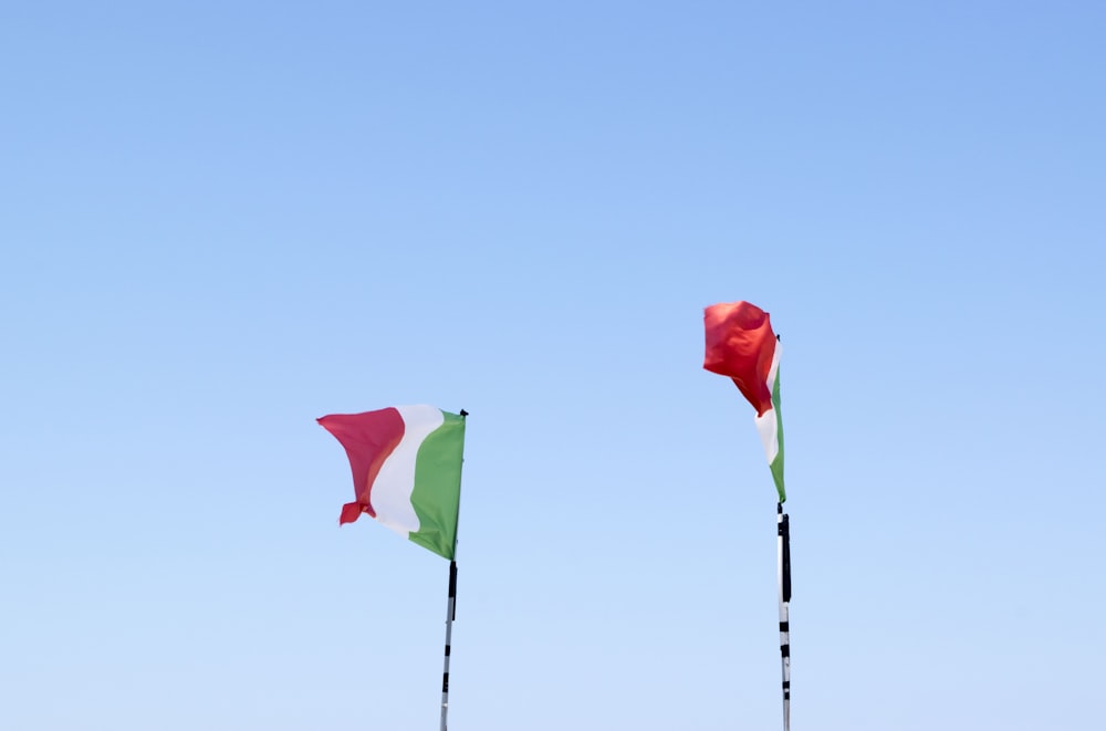 two flags of Italy on flag poles