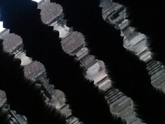 Dimly lit ancient temple interior with subtle mystical symbols blending Guarani and Egyptian motifs on dark stone walls.