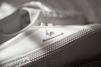 A close-up of a shoe being stitched.