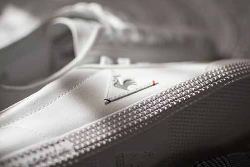 A close-up of a shoe being stitched.